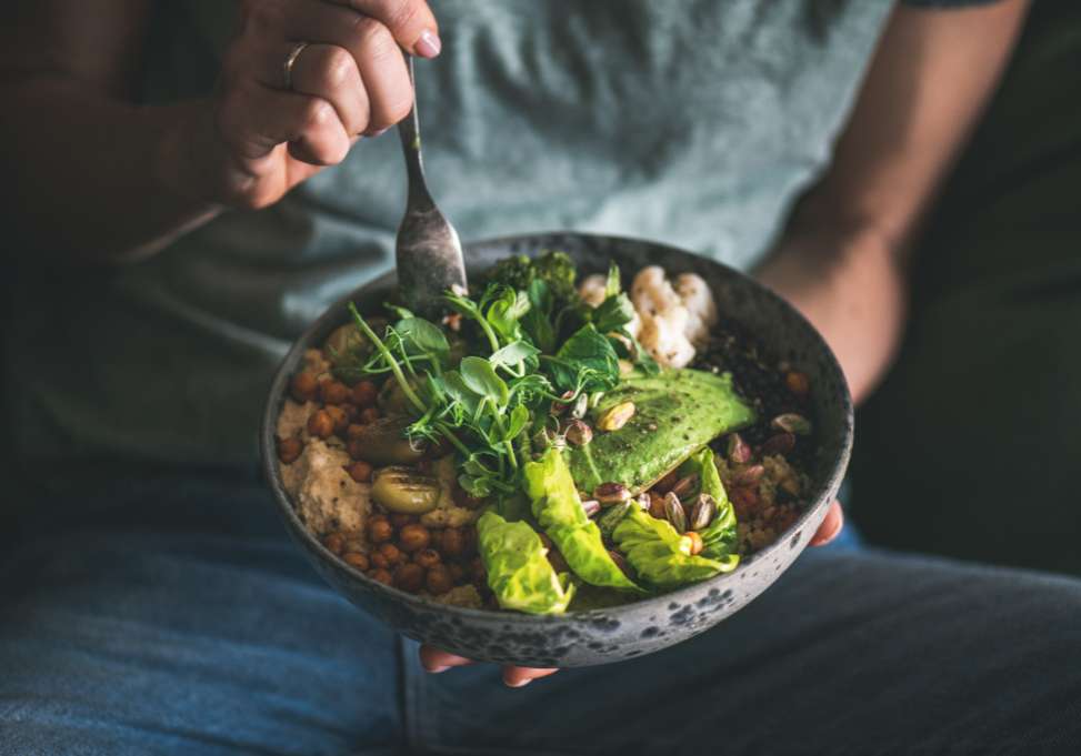 man eating vegan bowl Buddha bowl